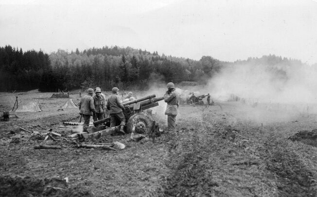 105mm howitzers of the 925th Field Artillery Battalion, 100th Division fire a barrage to stop a counter-attack in France. 