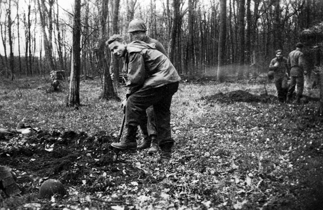 Pfc. Russell Hackett and other members of the author’s platoon dig foxholes in preparation for an enemy counterattack in the Bitche area, November 1944.