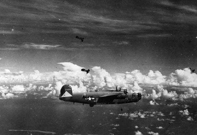 Flak bursts darken the sky around a flight of B-24 Liberator bombers on a mission. The versatile B-24 proved effective on high-altitude and antishipping missions, while also functioning in an antisubmarine role.