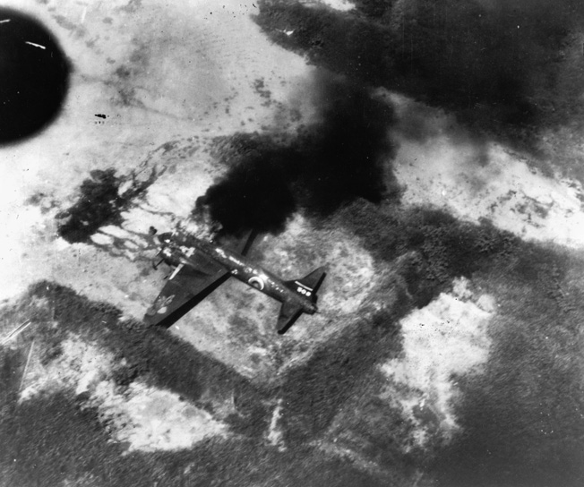  A Japanese bomber is slowly consumed by flames following a raid by American aircraft. As the war in the Pacific progressed, American bombing raids grew in strength and number and often caught Japanese aircraft on the ground.