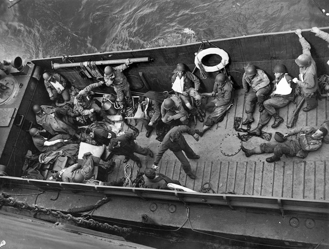 A few of the wounded soldiers evacuated from the Normandy beaches head back to the safety of Britain aboard a U.S. Coast Guard vessel. Medics braved murderous German fire to render aid to the wounded on Omaha Beach and often presented easy targets for German gunners despite their helmets emblazoned with red crosses.