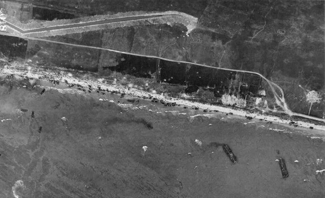 This aerial image of Omaha Beach on D-Day shows troops of the U.S. 1st and 29th Infantry Divisions struggling to reach cover and eventually advance against German fortifications. The situation on Omaha Beach remained in doubt for some time, and General Omar Bradley, commander of American invasion forces, considered evacuating the troops.