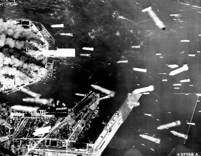 Incendiary bombs rain down on the waterfront installations of Osaka, 240 miles southwest of Tokyo, in June 1945. A series of raids in March, June, July, and August 1945 caused 10,000 deaths at Osaka.