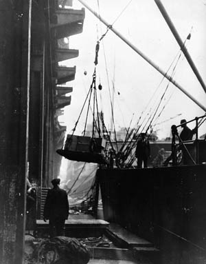 A sorely needed shipment of food reaches the docks of a British port city in December 1941.