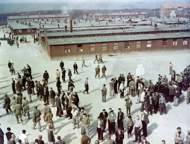 Waiting for transportation to Displaced Person Camps, former prisoners of Buchenwald who are able to walk mill around in the compound. Ultimately, they would be repatriated. This photo was taken from the guard tower near the main gate, which dominated the entire camp.