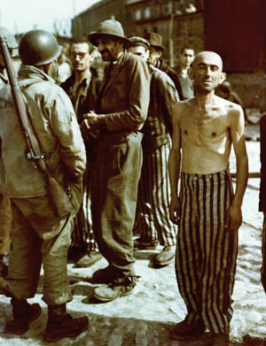 In this well-known photograph, American soldiers talk to newly liberated prisoners of the concentration camp at Buchenwald. Some are still wearing their striped prison uniforms, which were supplies to them by the Germans.