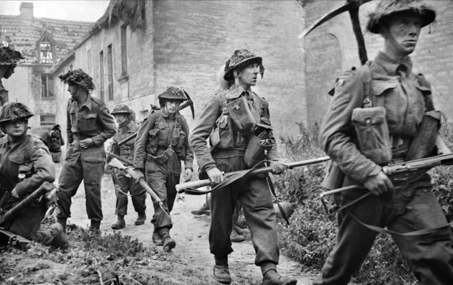 Picking their way through the village of St. Mauvieu-Norrey, British soldiers advance during Operation Epsom, one in a series of offensive operations launched by British General Bernard Montgomery to capture the Norman city of Caen. 