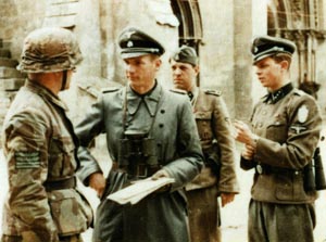 Officers and soldiers of the 12 SS Panzer Division Hitler Jugend confer during a pause in the fighting around Caen. This photo was taken in the village of Saint-Germain-la-Blanche-Herbe in front of the town’s famous Abbaye d’Ardennes. The ardent Nazis of the Hitler Jugend were known to have committed several war crimes in Normandy, executing Allied prisoners.