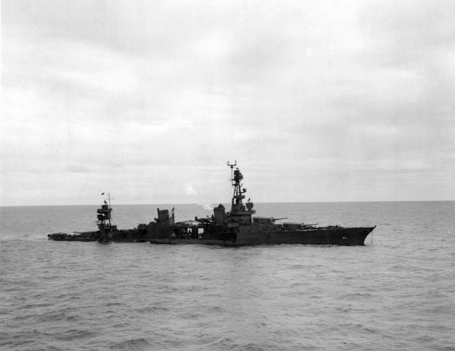 The USS Chicago is shown down by the stern following a night engagement with the Japanese off Rennell Island. Her radar apparatus has been blotted out by censors in this final photograph before the vessel was lost on January 30, 1943.