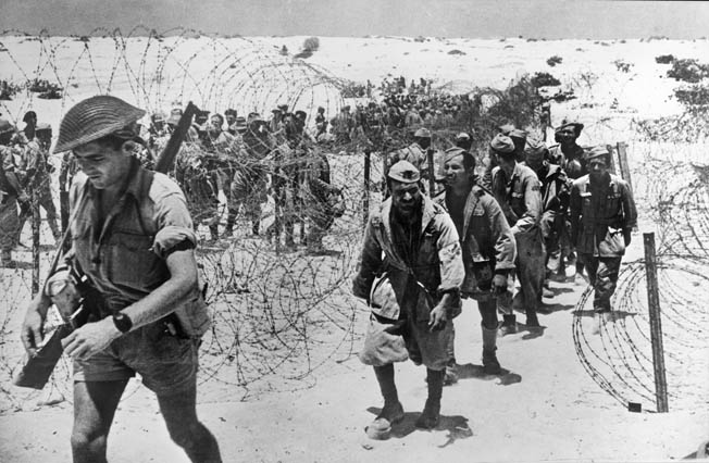 Italian prisoners of war march into captivity. After the defeat at El Alamein, the British Eighth Army pursued Panzerarmee Afrika westward across the North African desert.