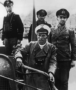 Their faces showing stubbly beards along with the stress of a recently completed wartime patrol, officers of a German U-boat pause for a photographer sometime in 1940.