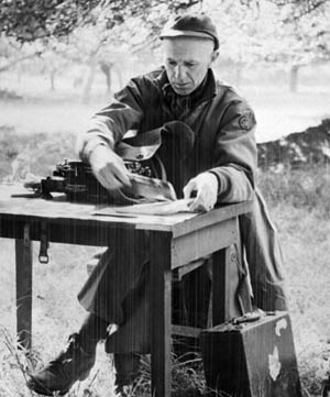 Pictured Pyle at a small table in Normandy.