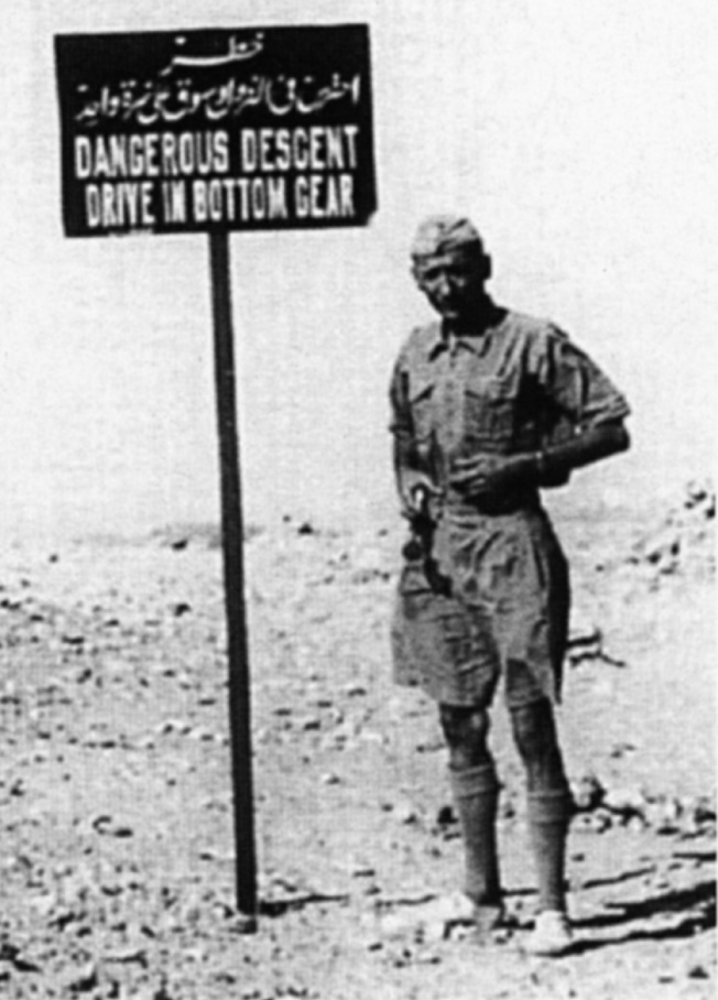 Almasy poses beside a warning sign (which he removed in a minor act of sabotage) at Yaboa Pass, 50 kilometers (31 miles) beyond Kharga oasis, before proceeding several hours more to the rim of the Egyptian plateau along the Nile Valley above Assiut, where he dropped off two spies of Operation Condor.