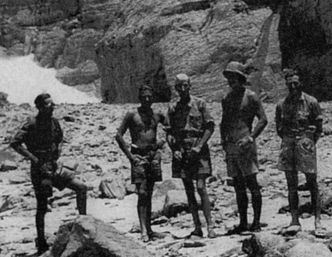 The Operation Salaam team poses at the mouth of Wadi Sura in the western escarpment of the Gilif Kebir. Almasy is at center wearing an overseas cap; Egyptian-born principal spy Johann (“John”) Eppler is on his right. The team paused to examine the “Cave of Swimmers,” one of several prehistoric painted caves that Almasy discovered in 1930-1933 in the Gilif and at Jebel U’weinat. 