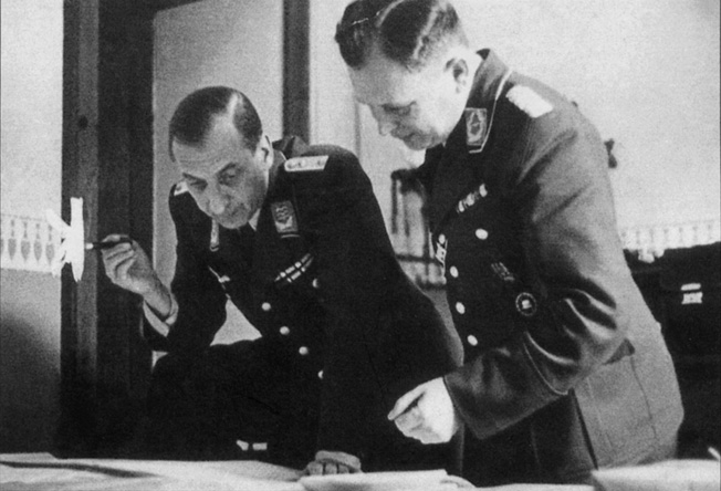 Almasy, in Hungarian uniform, and Major Nikolaus Ritter pore over maps of North Africa at Abwehr headquarters in Hamburg.