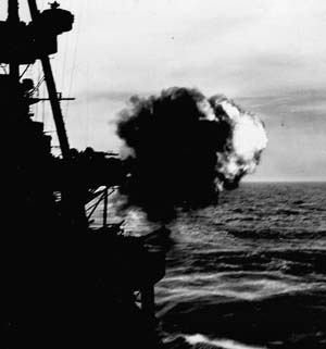 The cruiser USS Salt Lake City blasts enemy positions on Kiska in support of 35,000 U.S. and Canadian troops who stormed the beaches, August 1943.