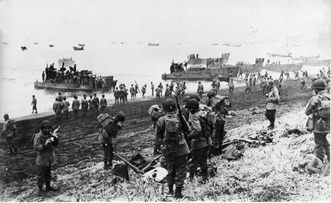 American troops and supplies are landed on the beach at Massacre Bay on Attu. Massacre Bay was one of the two locations where Allied soldiers came ashore and succeeded in cornering the Japanese.