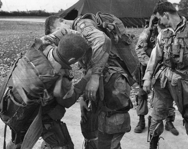 Men of the 82nd adjust gear before boarding their transports on June 5, 1944. 