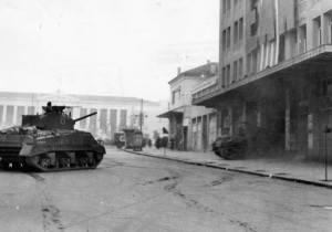 A British tank crashes through the door of the EAM Building in Athens during the effort to crush resistance by the Communist ELAS guerrillas. The Communists put up stiff resistance for several days. 