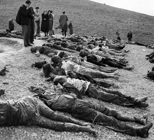The bodies of 120 victims of a massacre perpetrated by ELAS guerrillas on the outskirts of Athens are laid out for burial in a mass grave near where they were murdered. 