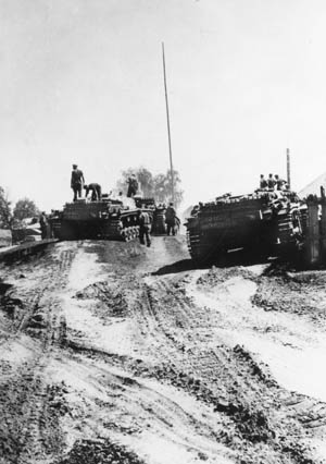 German tank soldiers survey the muddy quagmire in the immediate vicinity as they pause near the banks of the Dneiper River in the Ukraine. During the conquest of the region, elements of the 17th Army crossed the great river at the end of August 1941.