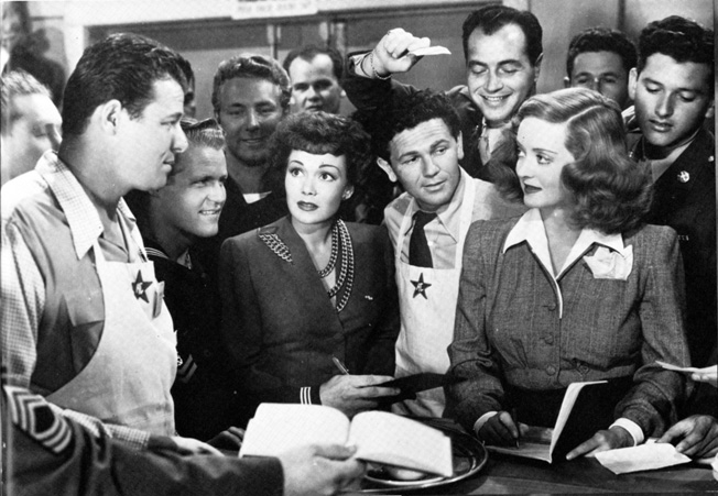 Bette Davis and John Garfield (right) were leaders in the Hollywood Canteen entertainment effort. Actors Jack Carson and Jane Wyman (left) were among the stars who contributed their time and talents to the canteen. Here admiring soldiers seek autographs and promotional photos.