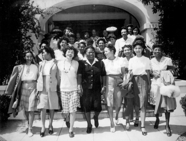 Famous for her Oscar-winning role in Gone with the Wind, actress Hattie McDaniel (center) served as chair-person of the Negro Division of the Hollywood Victory Committee. Here she leads a group of performers to Minter Field to entertain the troops stationed there.