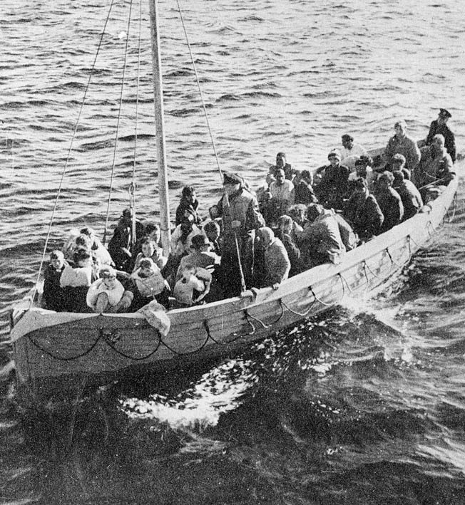 After being adrift eight days in the rough Atlantic, survivors of the sinking of the SS City of Benares are finally rescued. This boatload includes five children.
