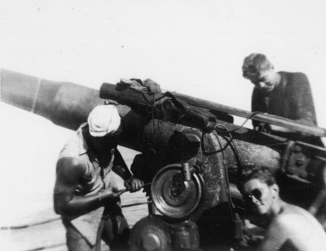 Aboard the merchant ship SS O.M. Bernuth, members of the vessel's Naval Armed guard operate a 4-inch gun.