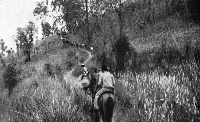 OSS operatives in Thailand negotiate a jungle trail on horseback during a clandestine operation against the Japanese. Divided loyalties among the Thai people contributed to the hazardous nature of duty in the Southeast Asian nation.