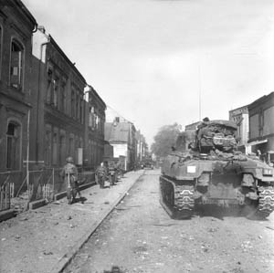 April 25, 1945: British Sherman tanks and accompanying infantrymen advance along the streets of Bremen, Germany, during the Western Allied invasion of Germany. The port city on the Weser River was a major objective of the final offensive mounted by the Allied 21st Army Group, commanded by Field Marshal Montgomery, in the spring of 1945.