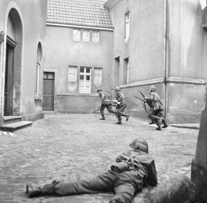 British infantrymen of the 3rd Division root out snipers in the city of Lingen, Germany, on April 7, 1945.