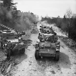 British half-tracks have yielded a dirt road to advancing Stuart light tanks and other vehicles of the 15th Scottish Division. This photo was taken on April 13, 1945, as the Allies advanced toward the Elbe River, deep inside Germany.