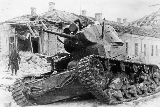 The charred hulk of a Soviet tank sits derelict following a clash with German armored units during a winter battle in 1942. 