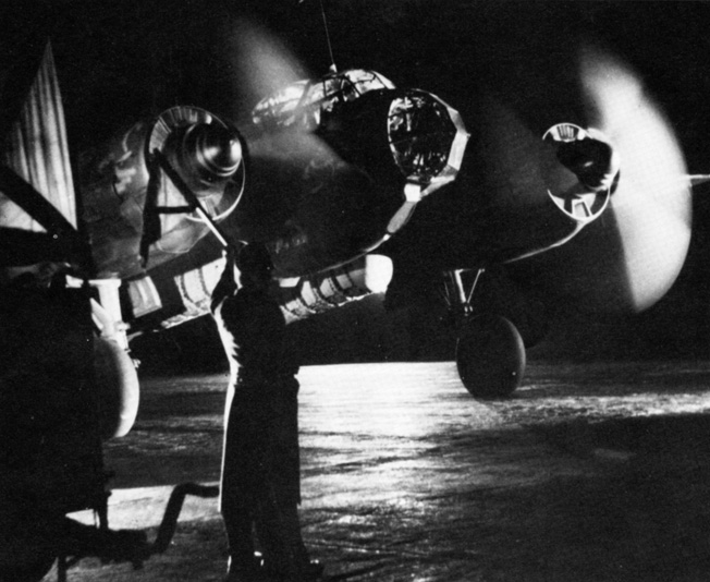 A ground crewman prepares a German Junkers Ju-88 bomber for a night attack against an English city during the Blitz.