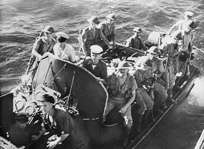 British commandos cling to the sides of a motor sailer as they prepare to assault objectives on Madagascar at the start of Operation Ironclad. 