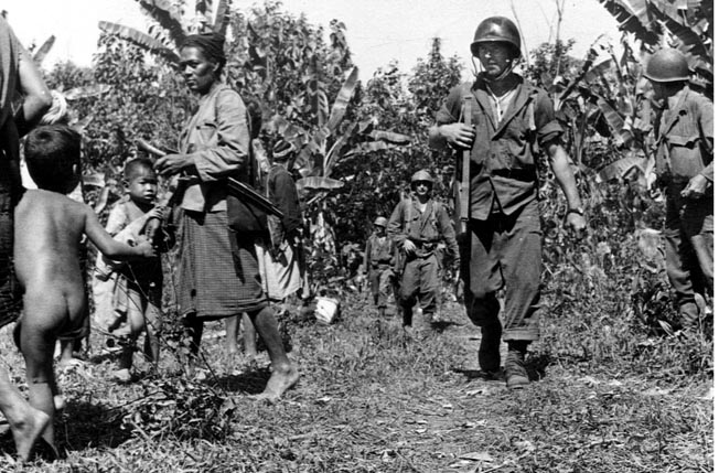Marauders move through a village along the Ledo Road while the natives look on. In truth, Burmese civilians welcomed the Americans as liberators from their brutal Japanese occupiers.