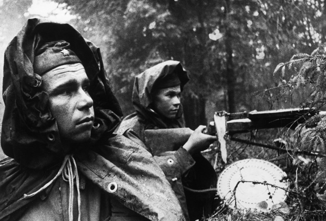 Wary Soviet infantrymen remain alert as the Germans approach defensive positions in a forest near Moscow in October 1941.