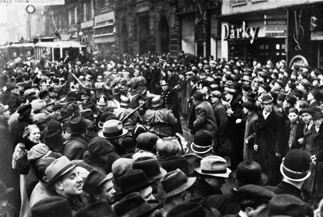 A subdued crowd in Prague watches as Germans roll into the Czech capital.