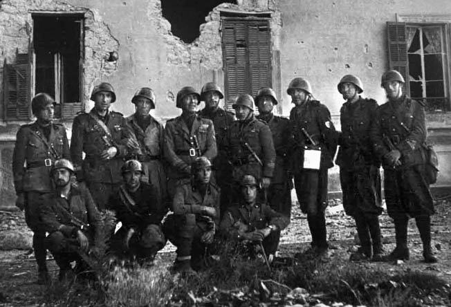 After capturing the French alpine town of Menton, Italian soldiers gather for a photo amid the ruins of a building that has been pummeled into rubble during the fighting. Italian forces met stiff resistance, and their offensive against France failed to produce the dazzling results that resulted from the German invasion.