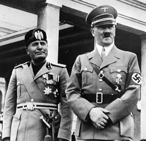 Managing to smile for the cameras, Mussolini (left) and Hitler greet the media following discussions in Munich in June 1940. The two Axis leaders reversed roles as the military situation in Europe developed, and Mussolini sought to assert his independence from the Germans with his assault on France.
