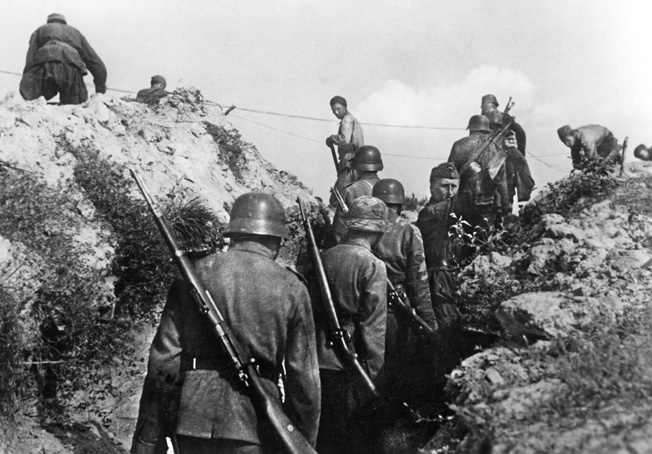 German soldiers dig trenches in preparation for a Soviet counterattack in the Leningrad area.