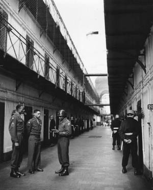 U.S. soldiers were ordered to keep a watchful eye on the prisoners inside the Palace of Justice. Howev- er, in spite of such orders, Robert Ley, head of the Nazi Labor Front, successfully committed suicide. Following Ley’s suicide, guards were posted at each cell and watched the prisoners 24 hours a day. 