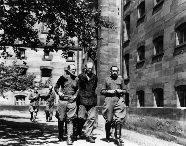 During one of their short exercise periods, prisoners on trial at Nuremberg walk and talk inside the prison courtyard. Although they were officially forbidden to confer, the guards often allowed them to talk quietly.