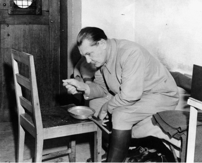 Former head of the German Luftwaffe Hermann Göring eats alone in his cell in the Palace of Justice at Nuremberg. He was able to take poison on the night he was scheduled to hang for war crimes. 
