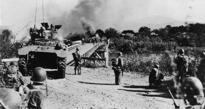  On January 30, 1945, an M4 Sherman medium tank crosses a bridge over the Matain River on Luzon.