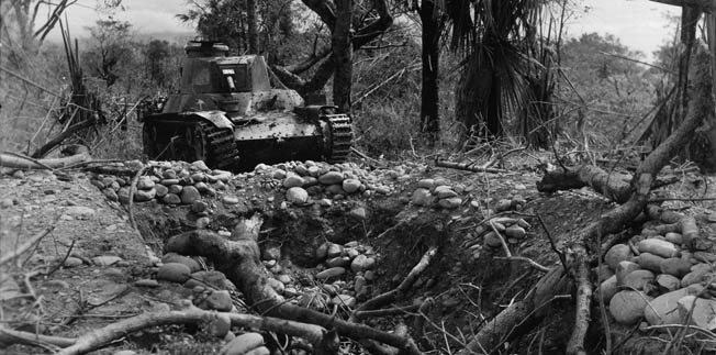 General Tomoyuki Yamashita ordered many of the 2nd Tank Division’s armored vehicles to fight from stationary positions due to fuel shortages. This Japanese tank is shown beside the earthen revetment dug for concealment near the village of San Manuel, Luzon.