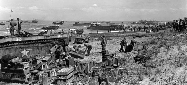 American soldiers unload ammunition from an amphibious tracked (Amtrak) vehicle that has come ashore at Yellow Beach, Lingayen Gulf, on the Philippine island of Luzon on January 9, 1945. In a rare move to defeat the Americans, the Japanese committed an entire armored division to defending Luzon.