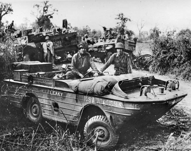 A corpsman holds a plasma bottle and rides beside a wounded man aboard an ambulance jeep on Okinawa in the spring of 1945. Although the ambulance jeep was used on all fronts, it gained a reputation for being somewhat unstable on narrow, mountainous roads.