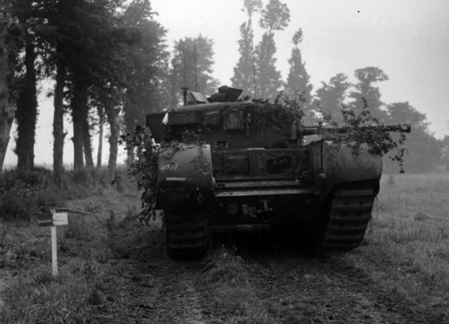 During Operation Epsom near the French town of Caen,a  Churchill tank of the 7th Royal Tank Regiment, 31st Tank Brigade moves along a dirt road. Branches have been placed about the hull as makeshift camouflage.